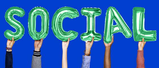 Green alphabet helium balloons forming the text social