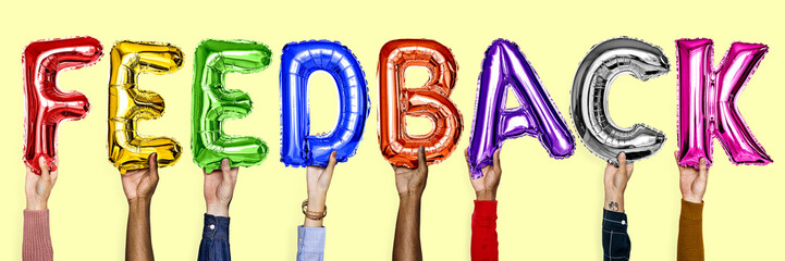 Rainbow alphabet helium balloons forming the text feedback
