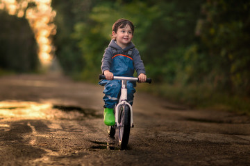 boy riding bicycle on the road