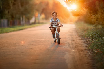 boy riding bicycle on the road
