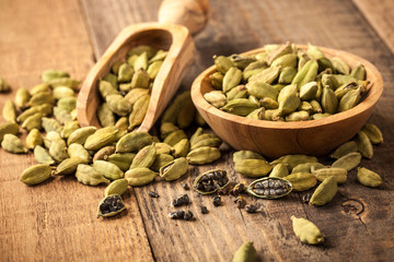 Green cardamom on wooden table
