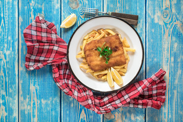 A piece of fried cod with fries on a plate.
