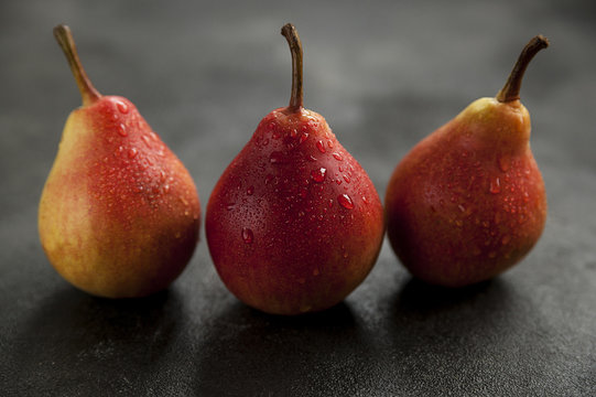 pears, ripe red pears on a dark background, fruit
