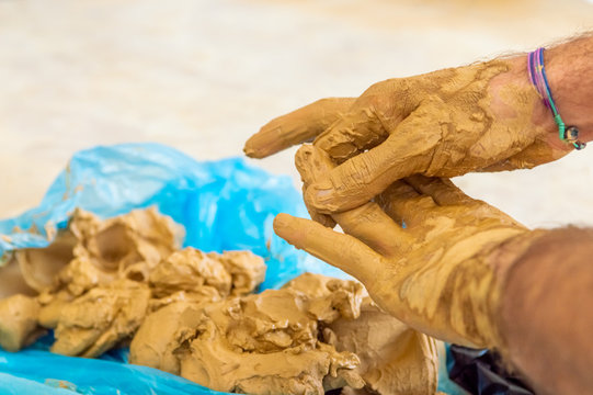 Male artist cleaning the clay on his hands