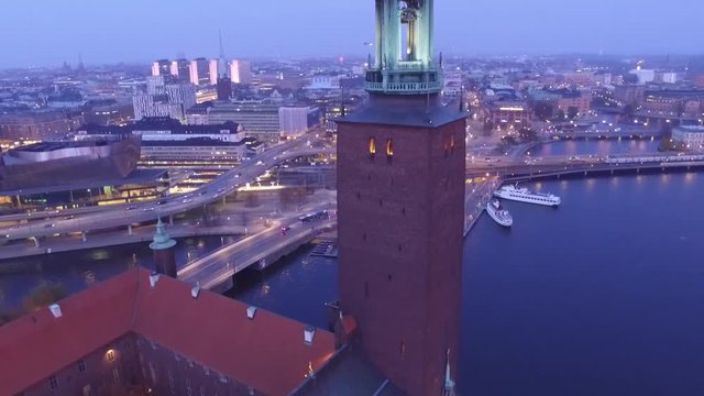 Stockholm City Hall by evening. Drone raising and revealing the golden top