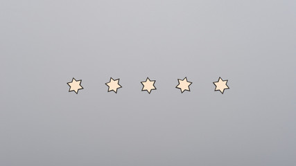 Five paper cut stars placed in a row