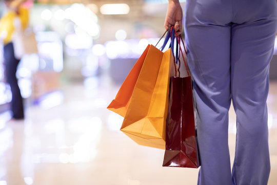 Close up Woman holding shopping bags in her hand walking in shopping mall,Shopping Concept