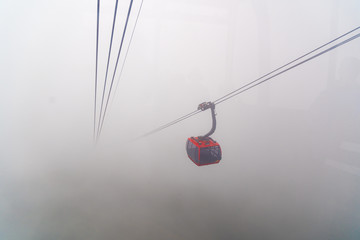 Cable car In the middle of the valley, fog in cloud background of country in Fansipan mountain SAPA VIETNAM.