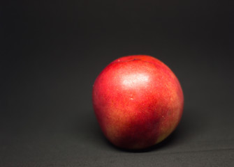 Fototapeta na wymiar smooth peach on a black background