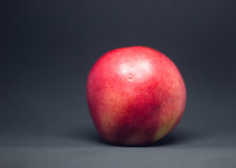 Fototapeta na wymiar smooth peach on a black background