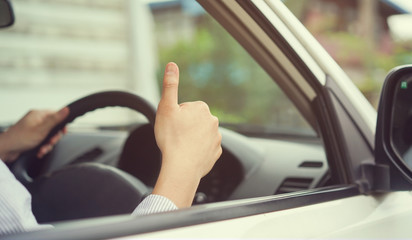 close up man hand showing thumb up of assurance of car safety first concept