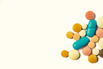 Drugs consumed orally. Colorful pills on a white background