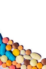 Drugs consumed orally. Colorful pills on a white background