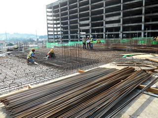 KUALA LUMPUR, MALAYSIA -AUGUST 09, 2018: Construction workers install concrete pipe culvert in the...