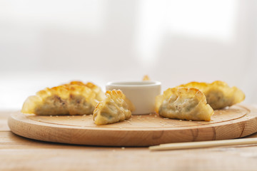 Delicious fried dumplings with soy sauce and sesame seeds. Asian cuisine
