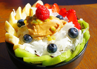View of a frozen acai bowl with fresh fruit and peanut butter