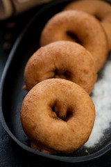 Close-up of freshly cooked donuts, vertical shot, selective focus