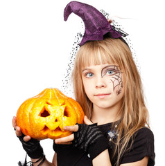 Little girl wearing witch halloween costume holding pumpkin isolated