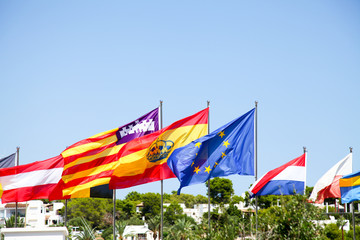 EU and European flags on flag poles in the wind