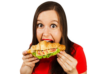 Young pretty smiling girl holds croissant with ham isolated on a white background.