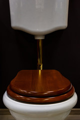 A new toilet with a tank on the wall