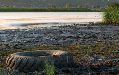 On the bank of the river discarded wheels