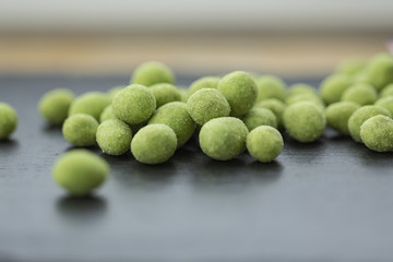 Snack, peanuts in the coating of wasabi. Close up