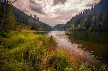 Beautiful lake in the mountains on a cloudy day shot in Romania