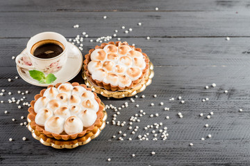 Sweet cheesecake and cup of coffee on the wooden background