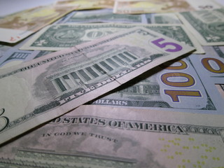 Fototapeta na wymiar US dollars laid out on the table.
