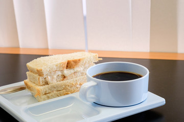 Hot Black coffee in blue cup with Sandwich Salad white bread for break snack at seminar
