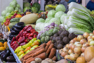 Assortment of fresh vegetables at market counter, vegetable shop