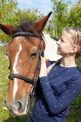 Portrait of young horsewoman and brown horse. Girl with horse.