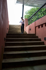 Obraz na płótnie Canvas man playing violin in a hall with stairs