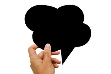 Hand holding an empty black hand-cuted paper speech bubble on white background. Isolated.