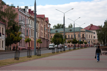 Sights and views of Grodno. Belarus. Street of the old city, buildings, pedestrians, city transport.
