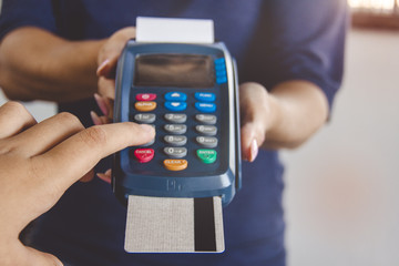 Credit card swipe through terminal for sale in store. Shopping and retail concept