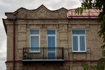Fototapeta na wymiar Grodno. Belarus. The pediment of the old brick house with brick-lined decorations and the date of construction of the house of 1910.