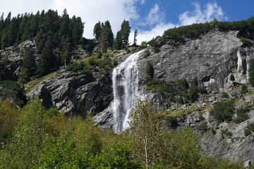 Fototapeta na wymiar Waterfall at a pass road in Austria in early autumn 