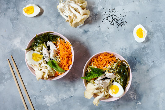Miso Ramen Asian noodles in bowls on concrete background.
