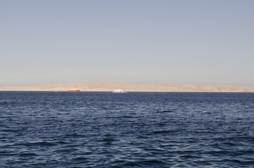 Fototapeta premium Sea and yachts with a shore in the distance