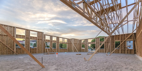 Sand and wooden beams in new construction pano