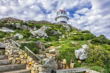 Old lighthouse (1857) sits on top of cliffs of Cape Point in Cape of Good Hope Nature Reserve on southern tip of Cape Peninsula in South Africa. The Atlantic and Indian oceans converge at Cape Point.
