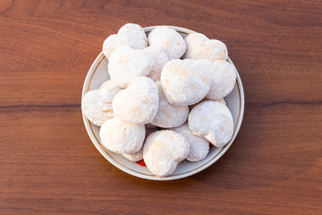 Plate with heart shaped cookies covered with powdered sugar