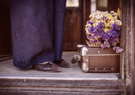 Suitcase, dried flowers and  fragment of female legs 2