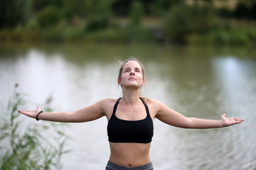 Yoga exercises outdoors / A young girl / Portrait