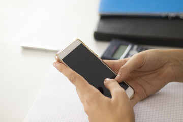 Woman using a smartphone with black screen