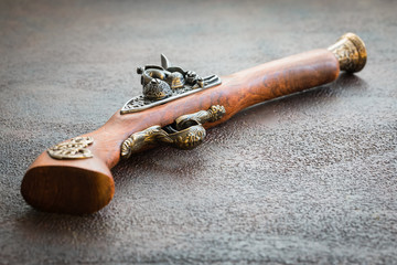 Old vintage wooden pistol on wooden background