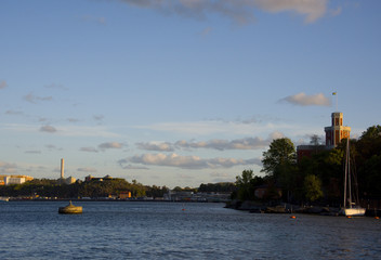 Boats and landmarks at Stockholm waterfront at sunset