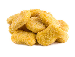 Frozen nuggets on a white background. Several chicken nuggets in breading close-up on a white background.